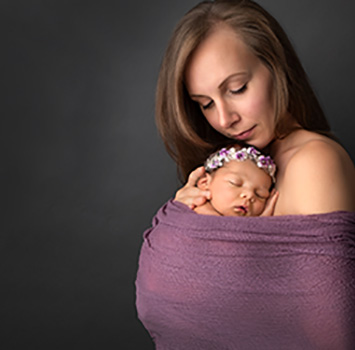 picture of new mother holding her new baby daughter in calgary newborn photoshoot