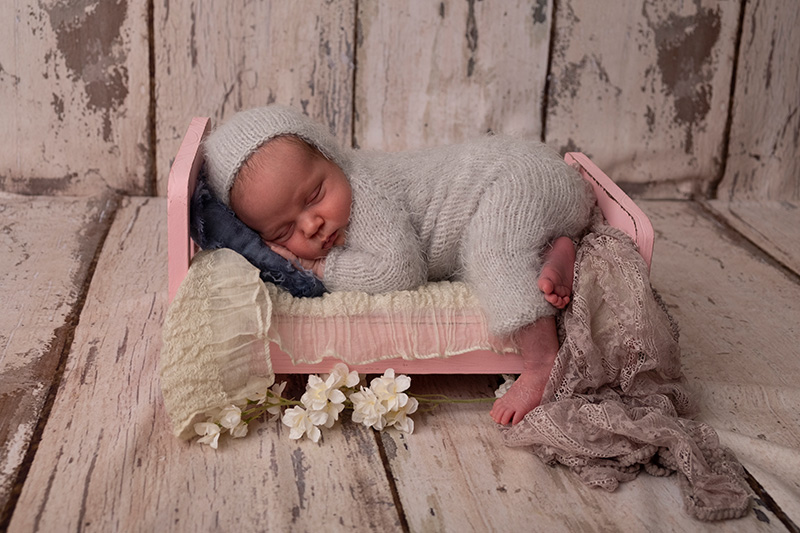 unedited image of newborn baby asleep in bed prop in newborn photography session in calgary alberta