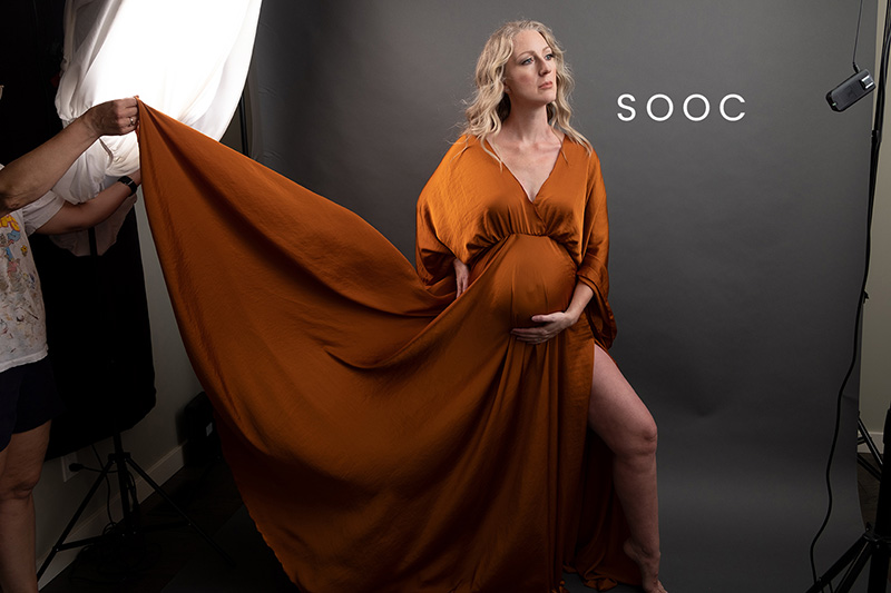 unedited image of maternity photography in calgary. Pregnant woman wearing cognac gown.