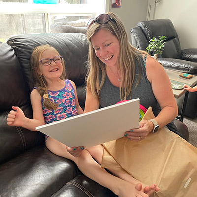 image of adorable client receiving wall art a