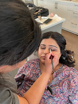 professional makeup being done on client in calgary studio for maternity session