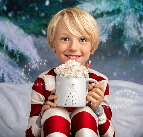 boy drinking hot cocoa in christmas photo at studio james photography